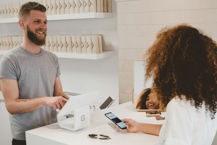 small-business-owner-receiving-a-transaction-at-a-counter-stock-photo